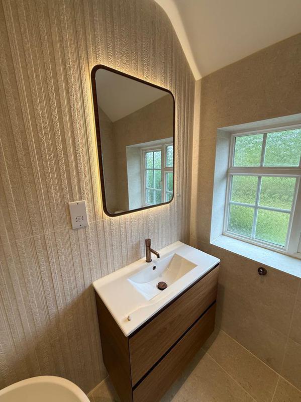 Wood-tone vanity unit with backlit mirror