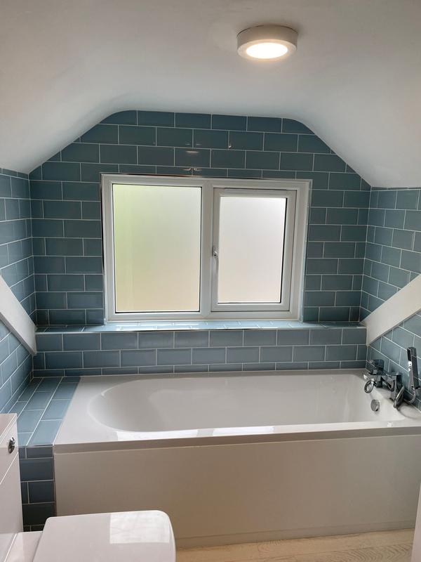 Loft bathroom with teal metro tile